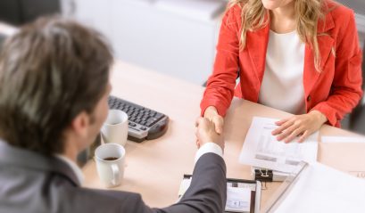 Male and female business people shaking hands